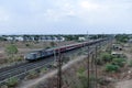 View of Indian Railways trains on the track and nearby electric poles Royalty Free Stock Photo