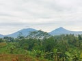 The view of Indonesia beautiful village is surrounded  by mountaints .Sindoro Merapi Merbabu Royalty Free Stock Photo
