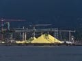 View of industrial area with huge piles of yellow colored sulphur stored for export in the port of North Vancouver.