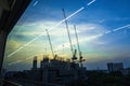 View of Industrial landscape with silhouettes of cranes on the sunset background From the windows of the electric train.Bangkok,