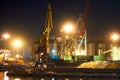 View of the industrial port at night - ships waiting for loading and unloading, cargo transportation by sea Royalty Free Stock Photo