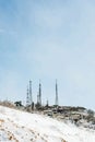 View of industrial towers on top of a hill during winter Royalty Free Stock Photo