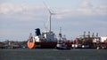 View of the industrial waterfront across Kill Van Kull strait, with a wind turbine