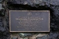 View of Information Board Plaque Strathcona Provincial Park on a stone wall