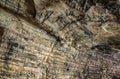 View inside the ancient cave with stone walls with additional lighting. Texture of a stone wall in a cave Royalty Free Stock Photo