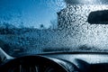 View from inside of automobile with windshield covered in frozen snowflakes. WInter driving conditions Royalty Free Stock Photo