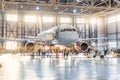 View inside the aviation hangar, the airplane mechanic working around the service