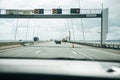 View from inside the car on an asphalt road through the Vasco da Gamma bridge in Lisbon