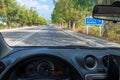 View from inside of car, blue traffic sign with directions to Rhodes town Rhodes, Greece