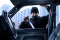 Person,criminal breaking into car in daytime Royalty Free Stock Photo