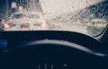 View from inside car window with rain drops on glass or the windshield,Blurred traffic on rainy day in the city Royalty Free Stock Photo