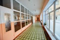 View inside the entrance corridor , old school or apartment building, dead end long and narrow walkway and glass window with