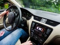 Wide angle view inside modern luxury car with female woman driving inside making Royalty Free Stock Photo