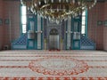 View inside a Mosque with a beautiful carpet and chandelier lamp on the ceiling Royalty Free Stock Photo