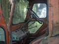 View Inside the old and rusty tractor cab. Abandoned agricultural machinery