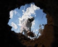 Ecologist digging pit by shovel and planting tree