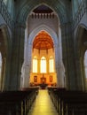 A view inside the Sacred Heart Cathedral looking down the nave past rows of wooden pews