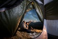 Two tourists have a rest in the camping in the mountains at night Royalty Free Stock Photo