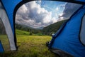 View from inside the tourist tent. Beautiful mountains, pine forest an clouds. Copy space. Vacation and hobbie. Carpathian