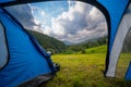 View from inside the tourist tent. Beautiful mountains, pine forest an clouds. Copy space. Vacation and hobbie. Carpathian