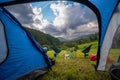 View from inside the tourist tent. The camp is ready for the night. portable chairs and a table, dinner with a view on mountains.