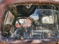 A view inside a vintage car through broken glass