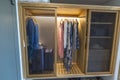 View of interior of the clothes in wardrobe and compartment for safe in hotel room. Royalty Free Stock Photo