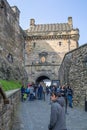 View at the interior Edinburgh Castle, detail of walls medieval fortress after principal gate, and tourists walking, on city of Royalty Free Stock Photo