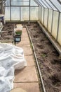 View of interior of greenhouse prepared for planting vegetables in early spring. Royalty Free Stock Photo