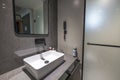 View of the interior of a hotel room with bathroom with guest accessories.