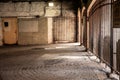 Interior of industrial grungy garage with gates.