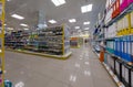 View of the interior of a MÃ¼ller retail store. Shelves on both side of the photo, filled with shool accessoires like maps, paper