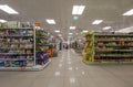 View of the interior of a MÃ¼ller retail store. Shelves on both side of the photo, filled with soap and food products