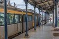 View of the interior of the train station in Coimbra, with people, trains and building