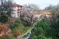 View of Irgandi bridge from Setbasi bridge, there is a creek below and a white apartment on the left