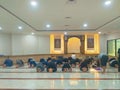 The view of the Islamic people are praying together in the masjid room