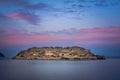 View of the island of Spinalonga at night with nice clouds and calm sea. Here were lepers.