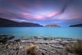 View of the island of Spinalonga at sunset with nice clouds and calm sea.