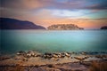 View of the island of Spinalonga at sunset with nice clouds and calm sea.