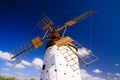 View on ancient white windmill with brown wings against blue sky with few scattered clouds - Fuerteventura, El Cotillo