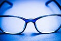 View on isolated blue eye glasses on blan background Royalty Free Stock Photo