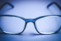 View on isolated blue eye glasses on blan background Royalty Free Stock Photo