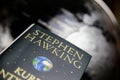 View on isolated  book cover of Stephen Hawking with blurred world globe background Royalty Free Stock Photo