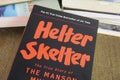 View on isolated book cover about story of manson murders with pile of books background