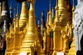 SHWE INDEIN PAGODA, MYANMAR - DECEMBER 23. 2015: View on isolated countless gold bright pagodas against blue sky