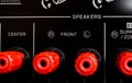 View on isolated red speaker outputs in a row of back side of black dolby surround home cinema receiver Royalty Free Stock Photo