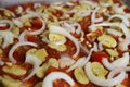 View on isolated vegan uncooked raw homemade fresh prepared pizza with basic ingredients tomato sauce, onions and champignons Royalty Free Stock Photo