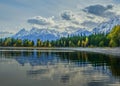 View of Jackson Lake in Grand Teton National Park with the reflection of the trees on the lake and the mountain range in the backg Royalty Free Stock Photo