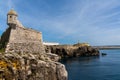 View of the jagged rocky coast and historic fortress in the center of Peniche
