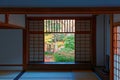 View of a Japanese courtyard garden through the sliding screen doors shoji of a room in Genko-an